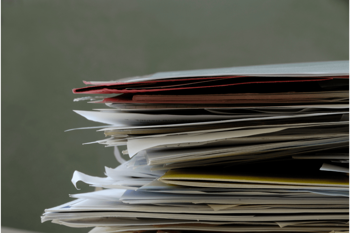 Stack of irrigation records and paperwork Stack of paper documents piled high, showing disorganised records and administrative workload